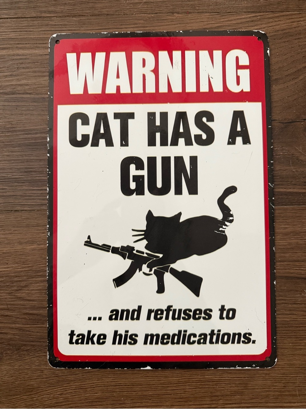 Warning Cat Has a Gun Metal Sign - Black and Red
